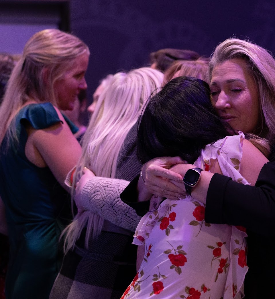 Two women embracing warmly